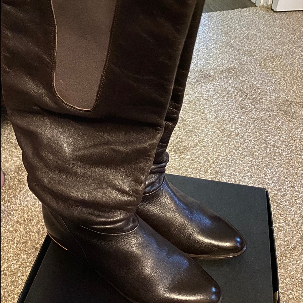 Black knee high length leather boots